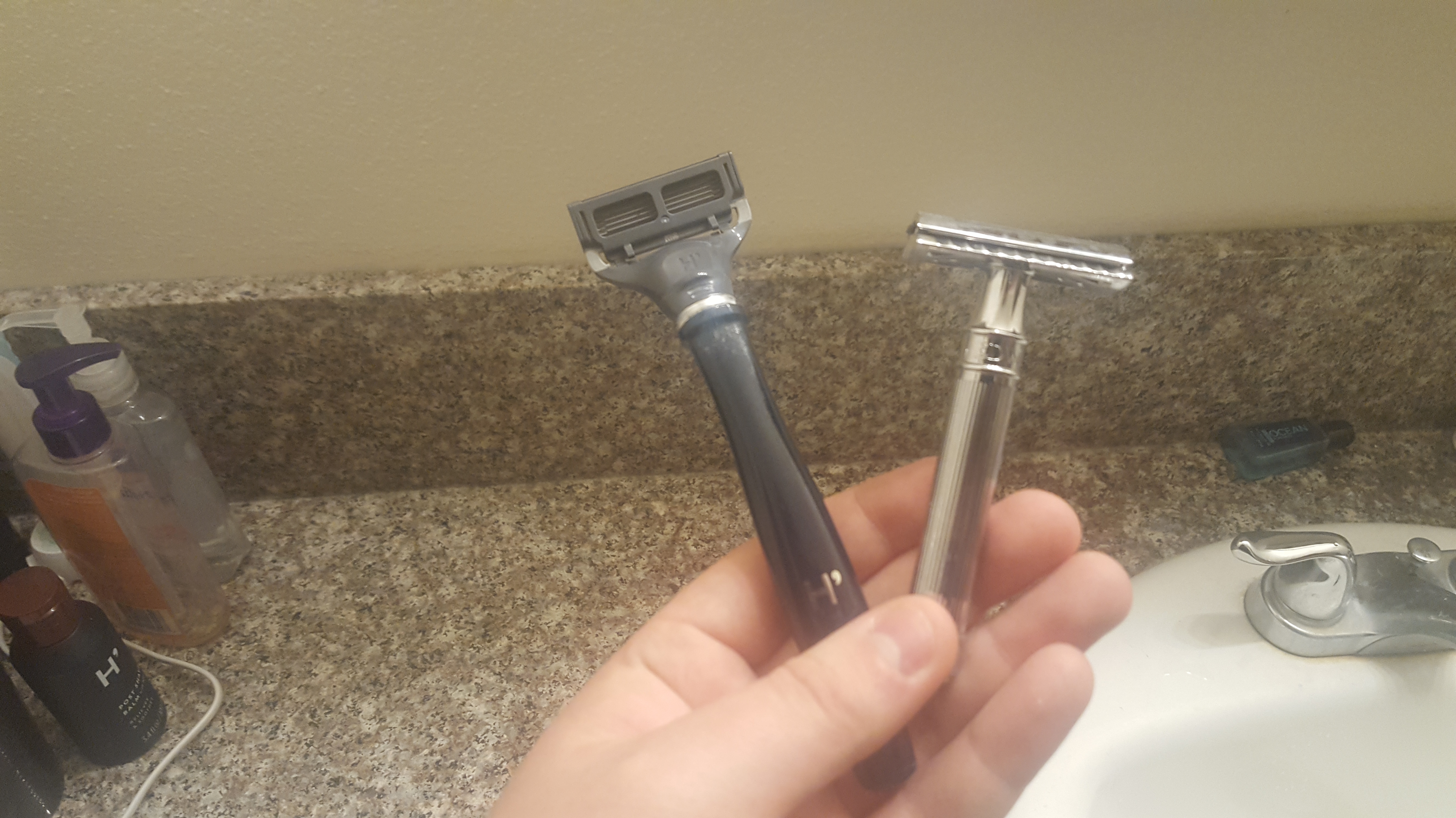 A cartridge razor and safety razor side by side.