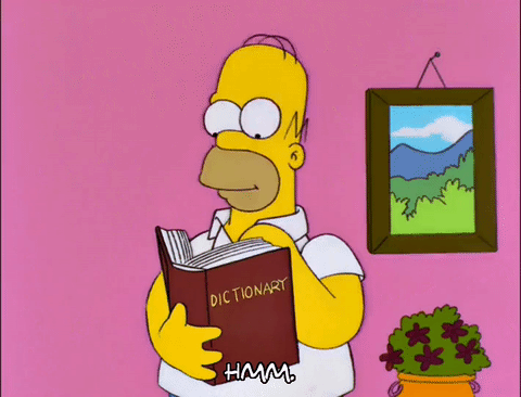 Homer from the Simpsons reads a dictionary while saying Hmm.